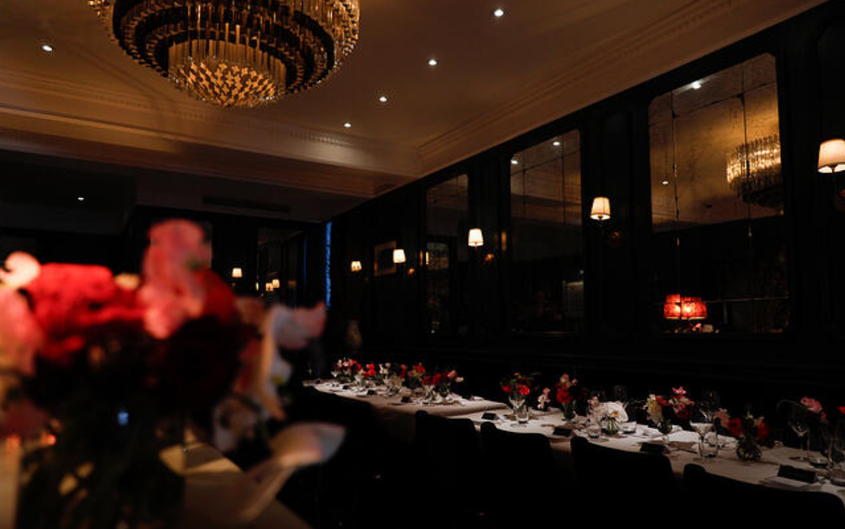 The private dining room at Le B, one long table set with flowers