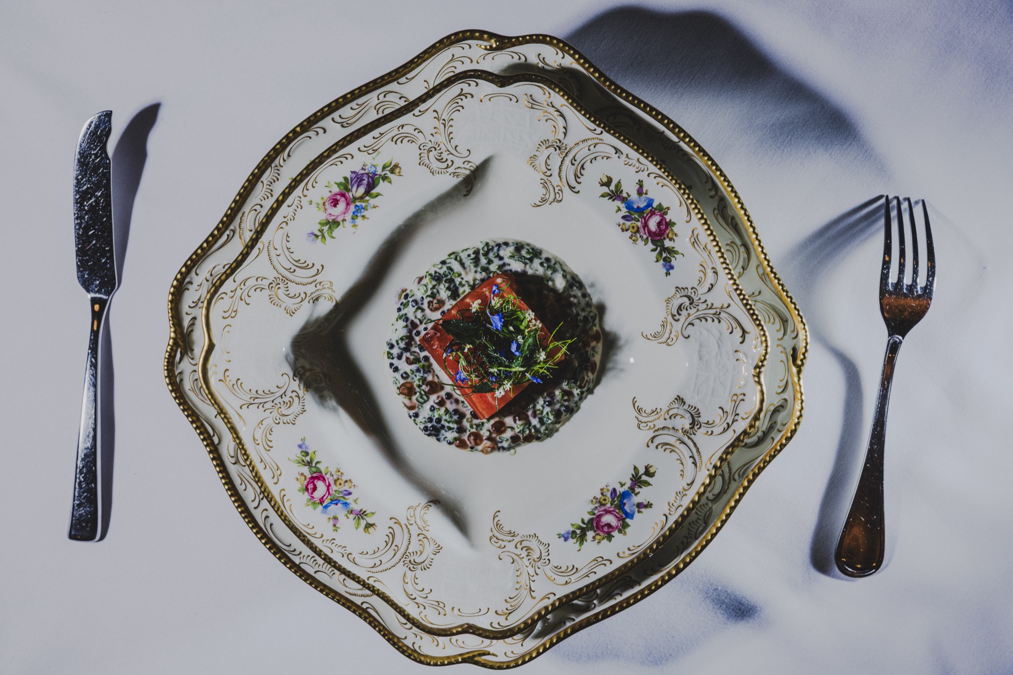 Trout on floral china, silver at each side