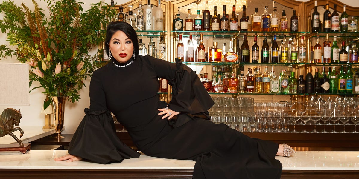 Angie Mar seated on the bar at Les Trois Chevaux